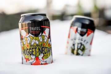 Double Nugget and Nugget Necar 16-oz. cans in snow.