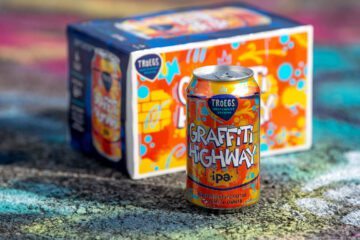 Graffiti Highway can and 6-pack on highway.